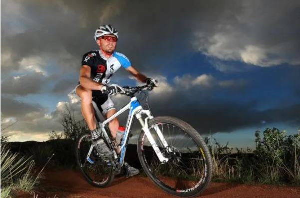 Mountain biker on path up close at dusk