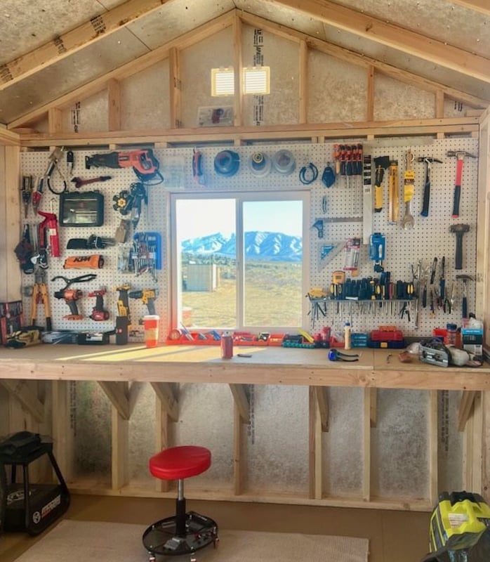 Tuff Shed interior with workbench and pegboard