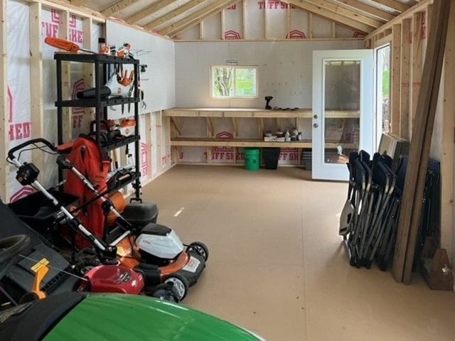 Interior of Tuff Shed with lawn mowers and shelving